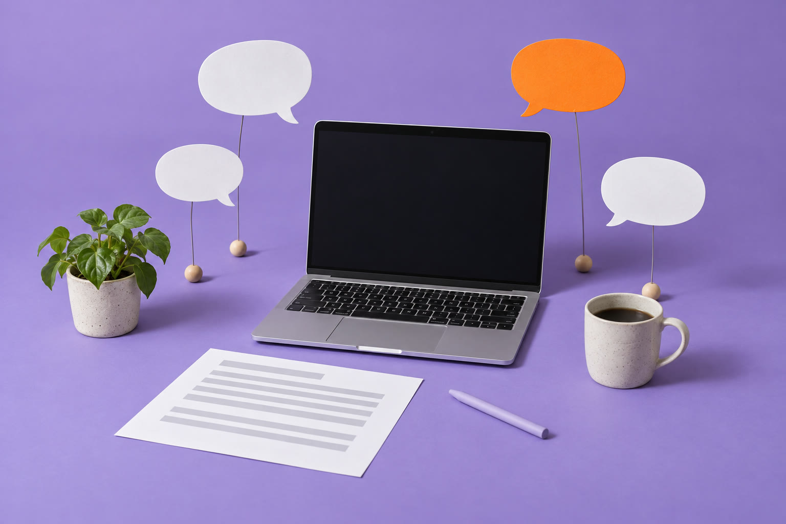 A laptop with blank paper speech bubbles around it and a resume page in front